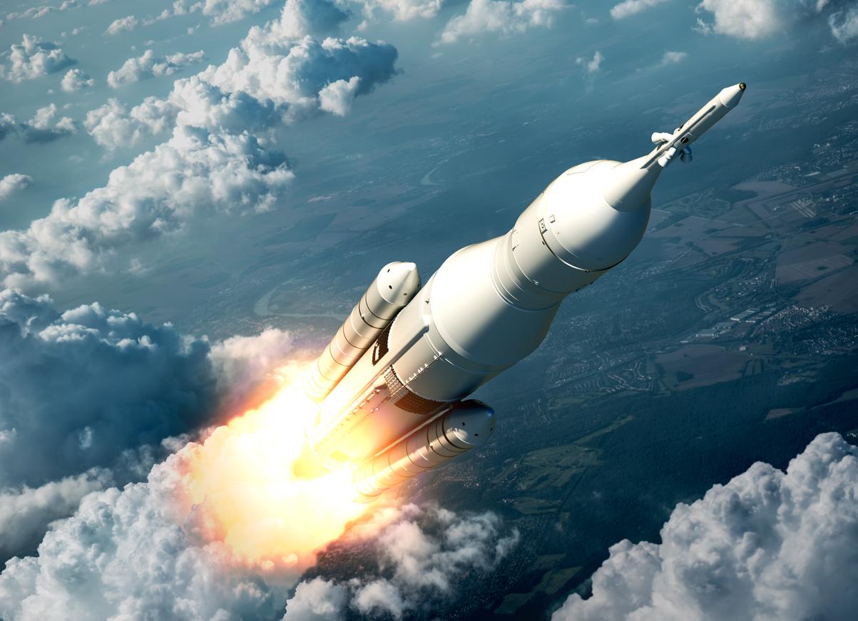 Space launch accelerating into the clouds.