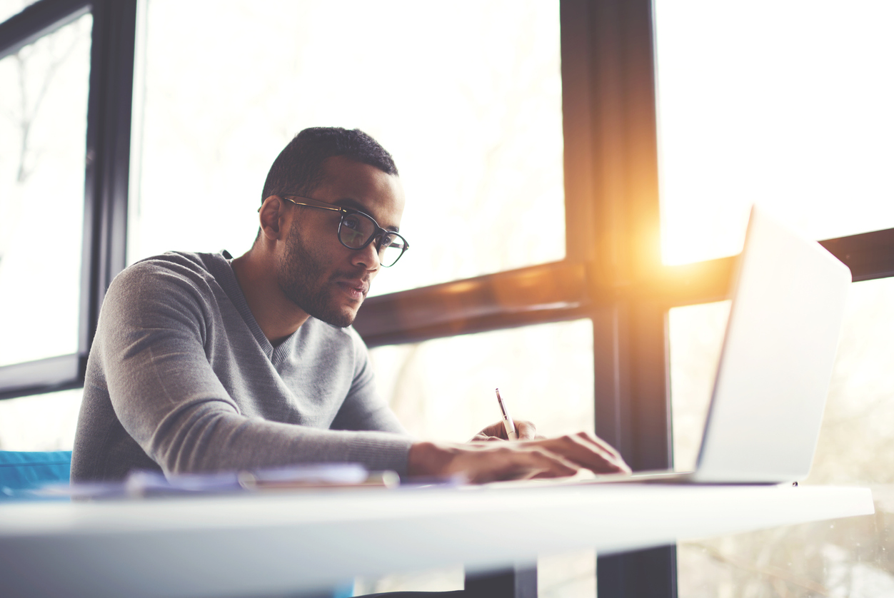 man in deep thought working at computer